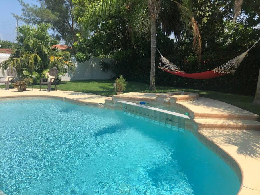 a swimming pool with a hammock in a yard at Beach and Pool, what more do you need? in Clearwater Beach
