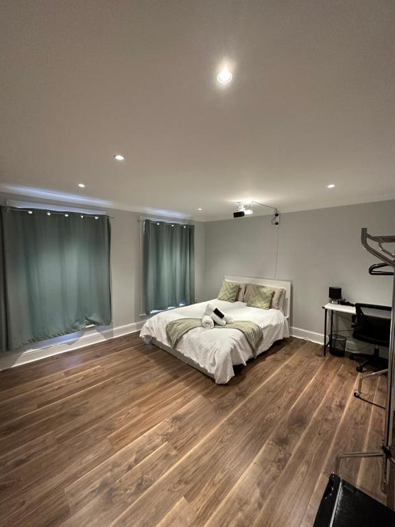 a bedroom with a bed and a piano at Liverpool Street Green Bedroom in London