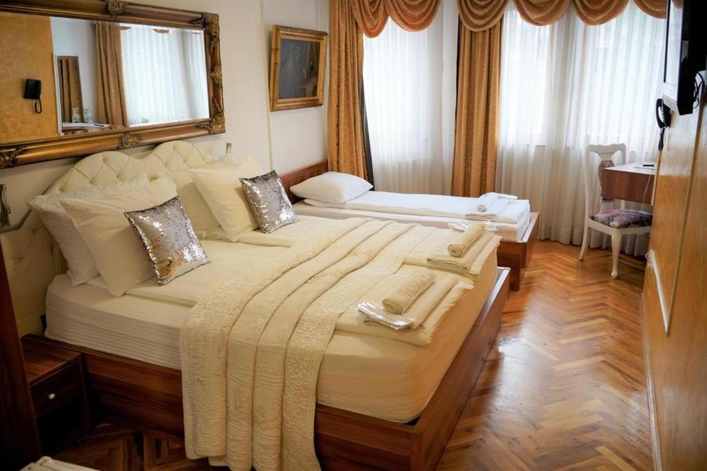 a hotel room with two beds in a room at Hotel Herc Sarajevo in Sarajevo
