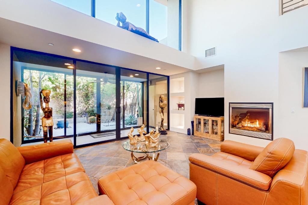 a living room with two couches and a fireplace at Thai Palomino in Palm Springs