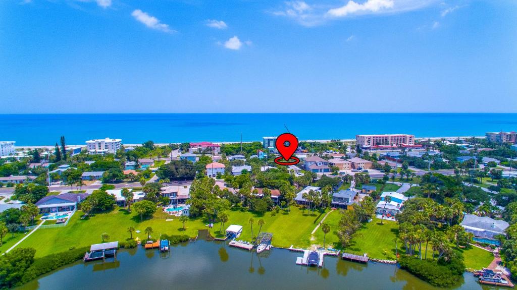 an aerial view of a resort near the water with a red marker at Beach Bungalow By The Sea 1 in Cocoa Beach