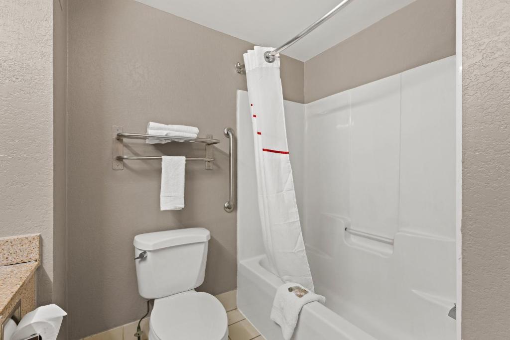 a bathroom with a toilet and a shower at Red Roof Inn & Suites Newnan in Newnan