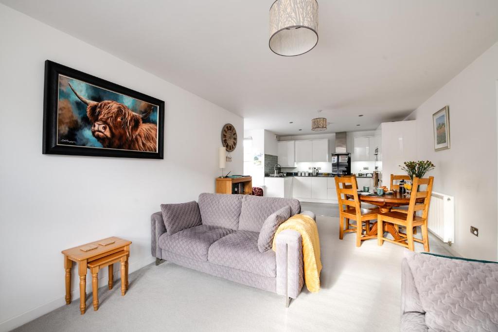 a living room with a couch and a table at Spire View - New Forest Holiday Home in Lyndhurst