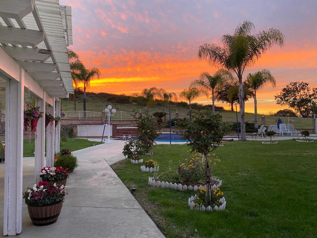 a sunset over a garden with flowers in a yard at 美景双人大房 Big Double bed with beautiful view in Chino Hills