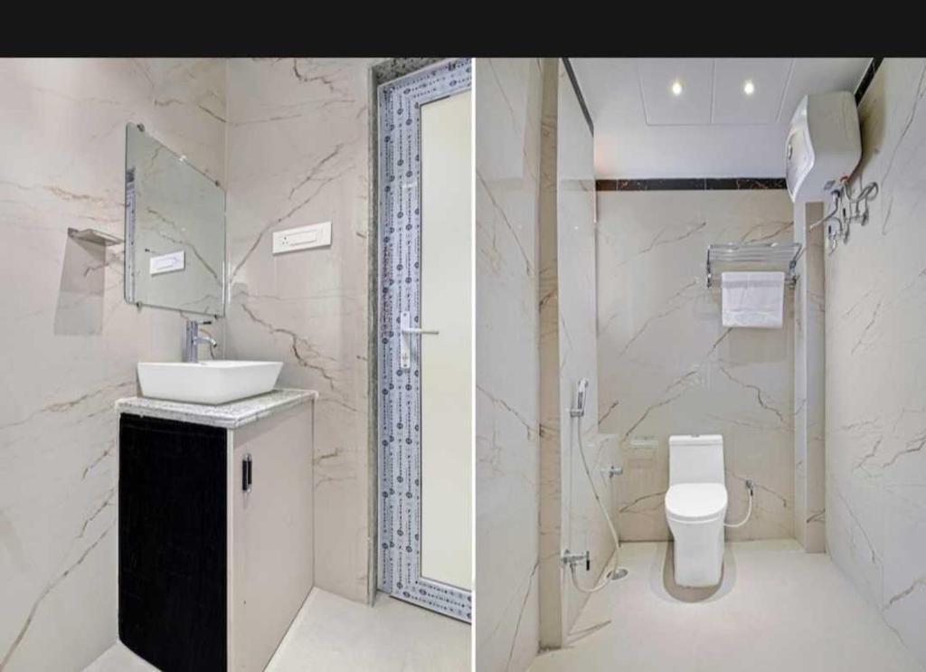 a white bathroom with a sink and a toilet at Flagship Hotel Heaven in Patna