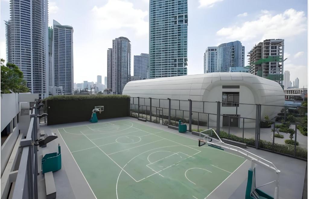 a tennis court on the roof of a building at DFT Apartment "Rockwell View" Host By HomeStay in Manila