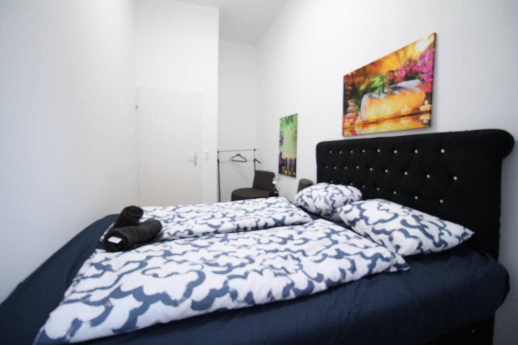 a bed with a blue comforter and pillows on it at Modern Double room JS b in Vienna