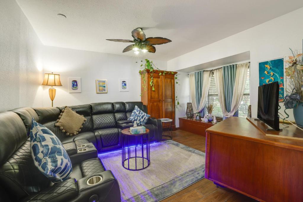 a living room with a leather couch and a table at San Antonio Vacation Rental about 15 Mi to Downtown! in San Antonio