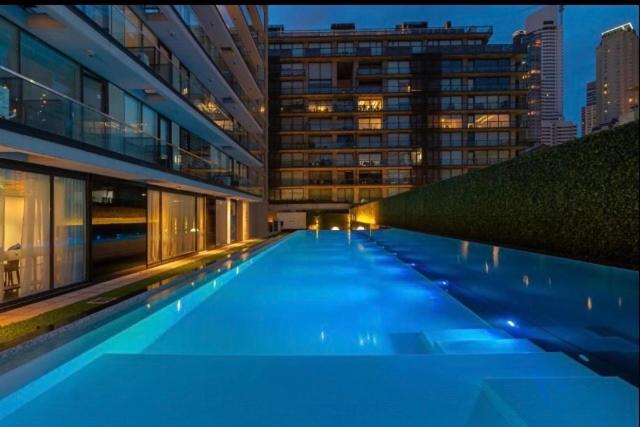 a large building with a swimming pool at night at Madero City Buenos Aires in Buenos Aires