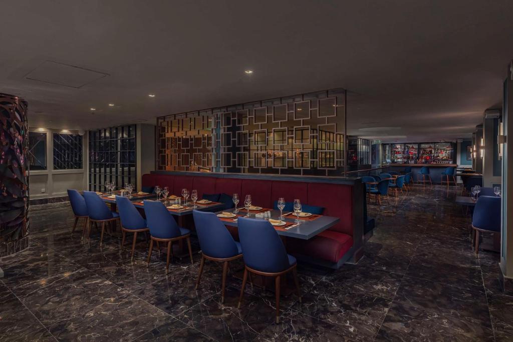 a restaurant with blue chairs and tables in a room at Radisson Blu Hotel, Cairo Heliopolis in Cairo