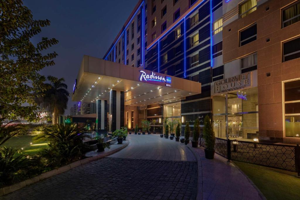 a building with a sign that reads raffles hotel at Radisson Blu Hotel, Cairo Heliopolis in Cairo