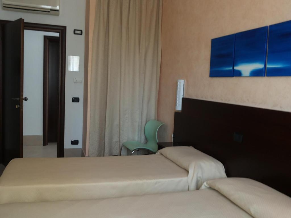 Posteľ alebo postele v izbe v ubytovaní Hotel Villa Ionia