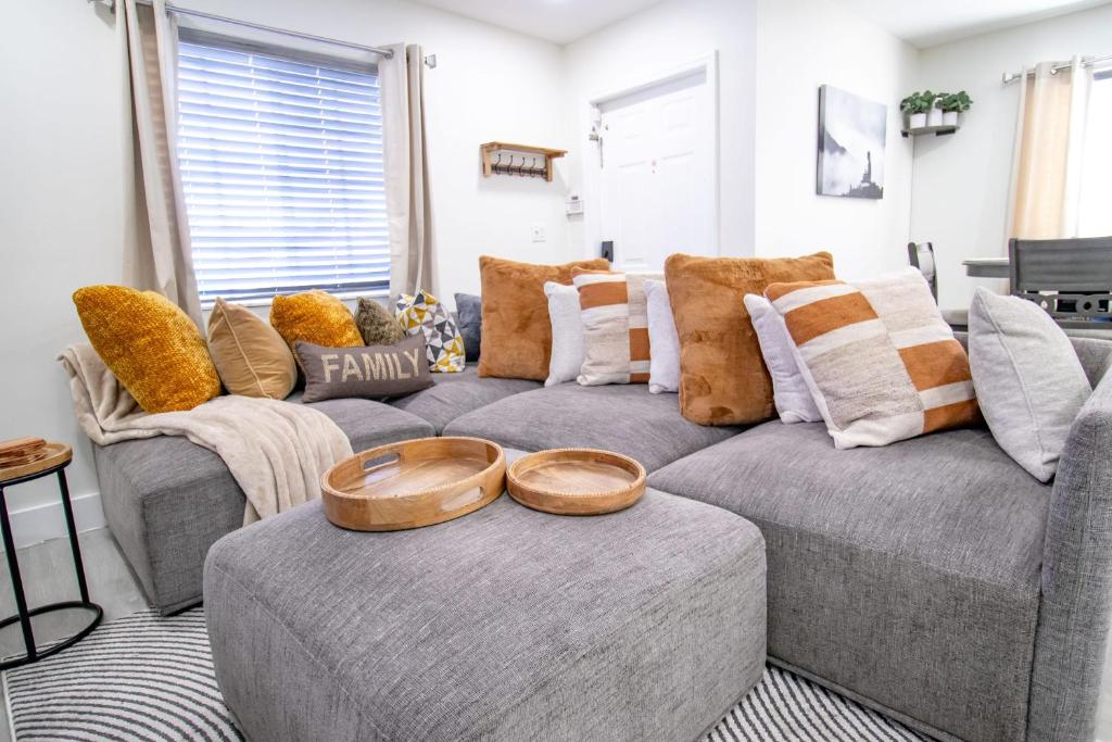 a living room with a gray couch and pillows at Good Vibes Oasis - Cozy townhome with parking in Cutler Bay