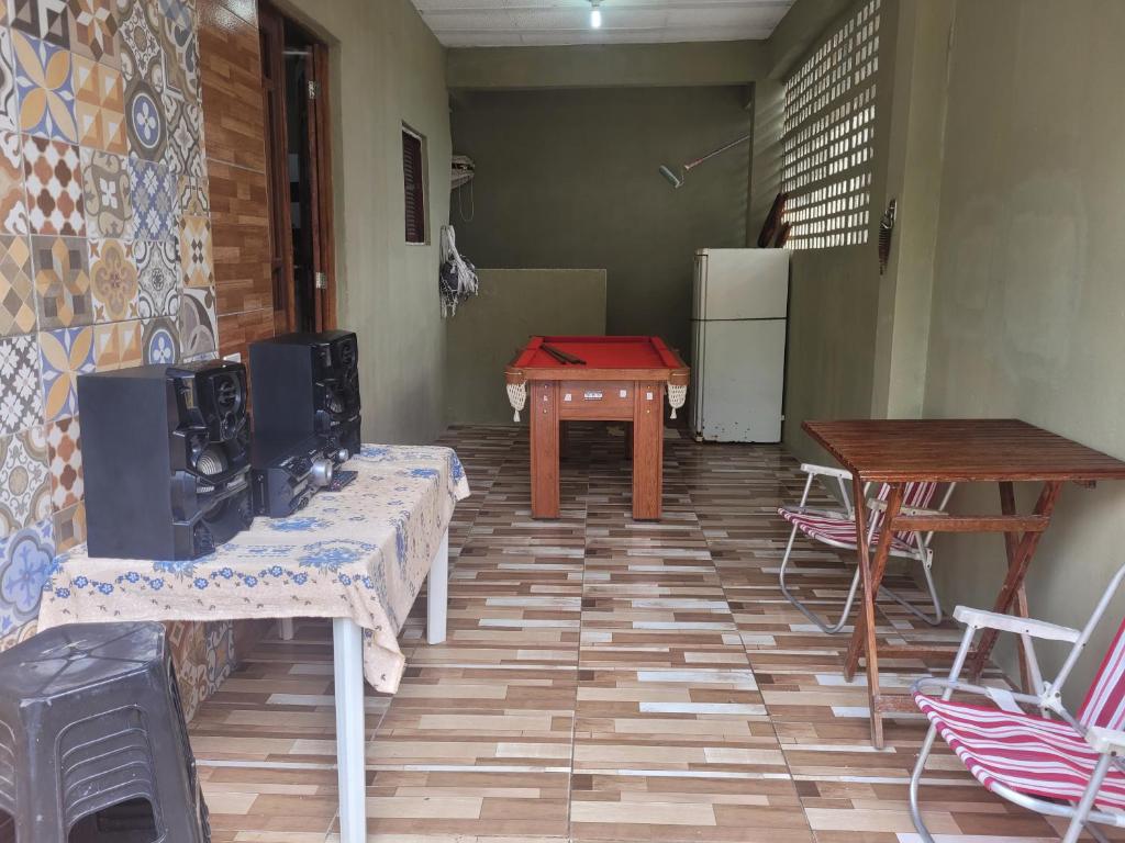 uma sala de estar com uma mesa e um frigorífico em Casa de praia em carne de vaca em Goiana