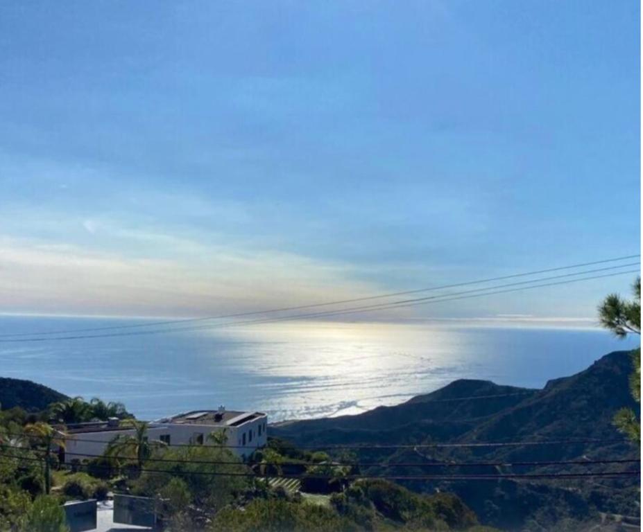 a view of the ocean from a hill with a house at Lux Villa Ocean View Pool &Spa in Malibu