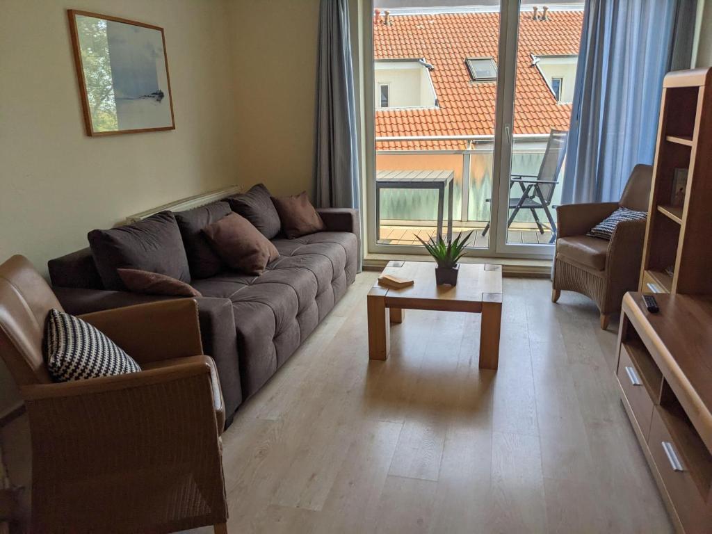a living room with a couch and a coffee table at Yachthafenresidenz-Wohnung-6303-773 in Kühlungsborn