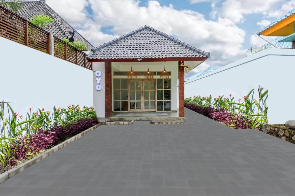 a walkway leading to the front door of a house at OYO 2896 Uma Menuh Guest House Near Pantai Keramas in Keramas
