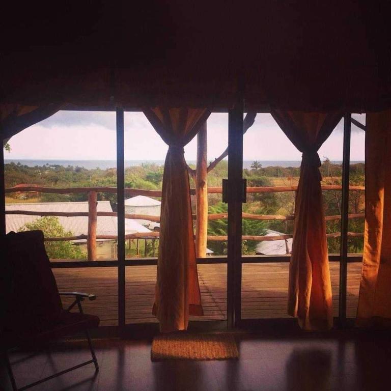 a room with a window with a view of a deck at Atavai Hotel Rapa Nui in Hanga Roa