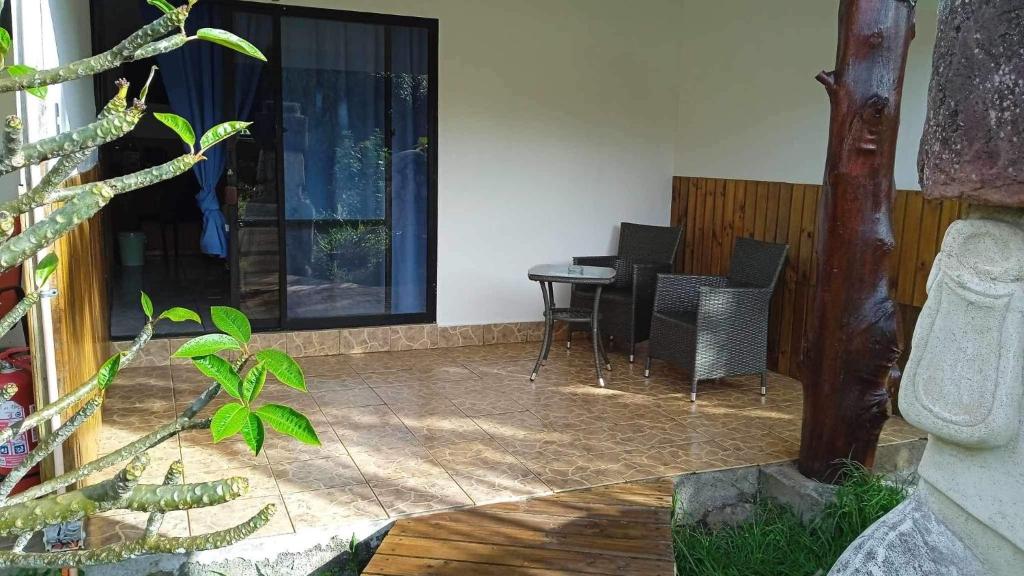 a living room with a table and a piano at Atavai Hotel Rapa Nui in Hanga Roa