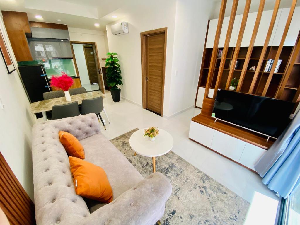 a living room with a couch and a television at OSIMI Apartment - 1 Bedroom - A0817 in Phú Mỹ