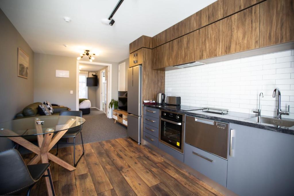 a kitchen with a counter and a table in a room at The Residence Apartment 9 50 Sky in New Plymouth