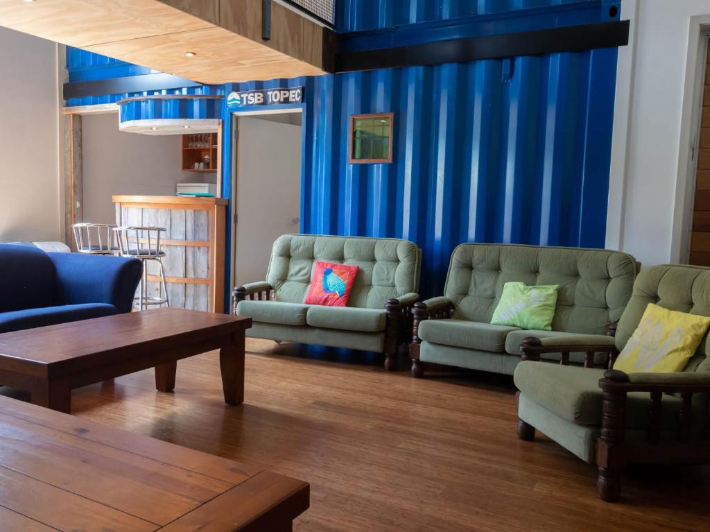 a living room with two couches and a table at The Eco Lodge Tsb Topec in Hillsborough