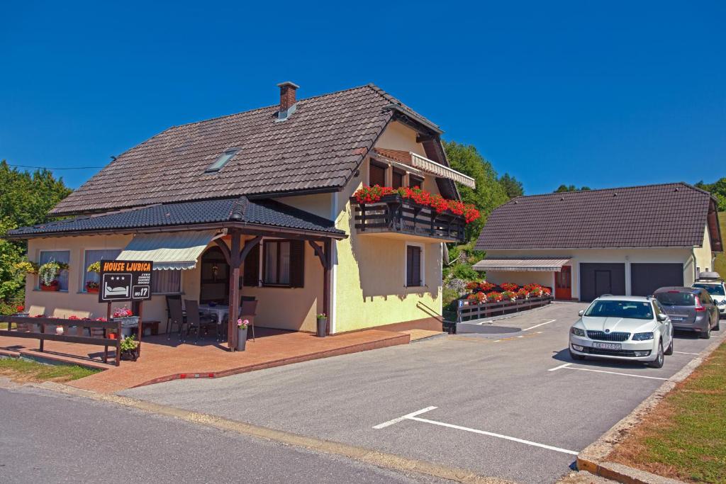 a car parked in a parking lot in front of a building at Guest House Ljubica in Rastovača