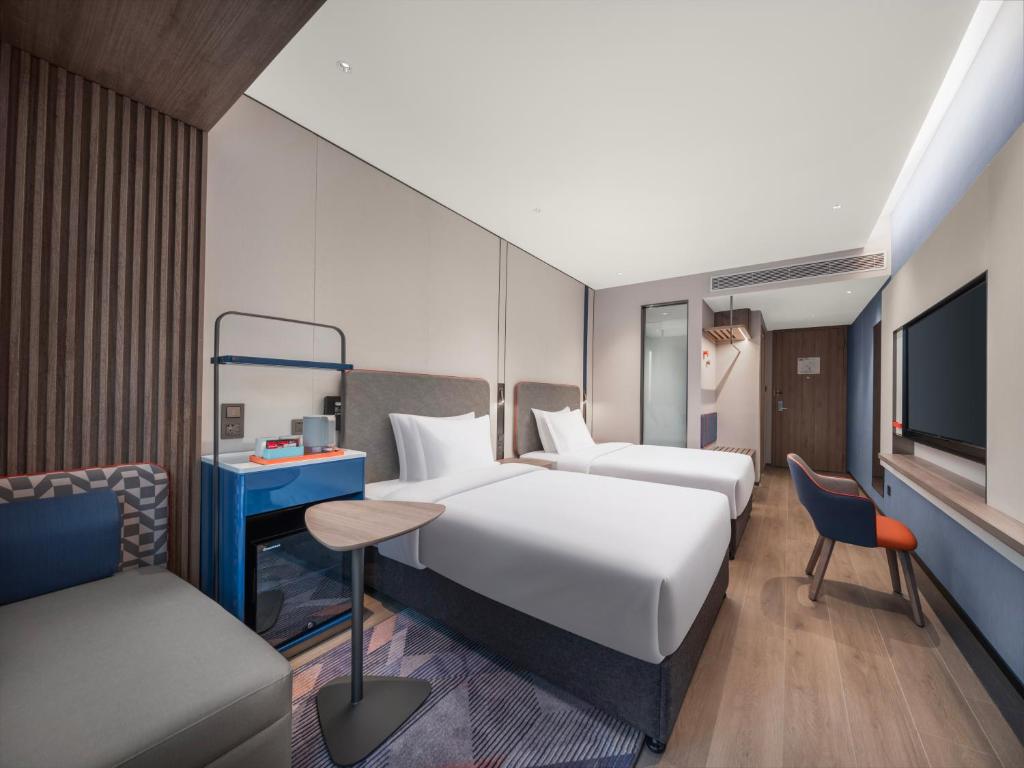 Postel nebo postele na pokoji v ubytování Holiday Inn Express Shanghai Hongqiao Linkong by IHG