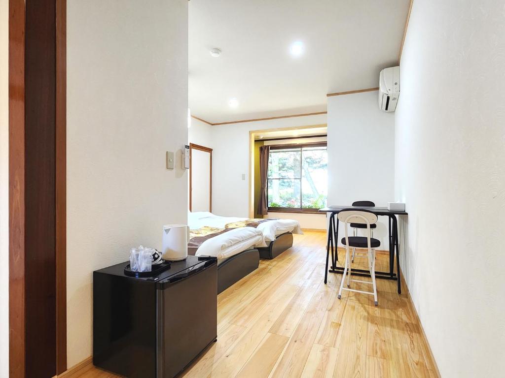 Postel nebo postele na pokoji v ubytování Guest Room Furusatomura Kogeikan