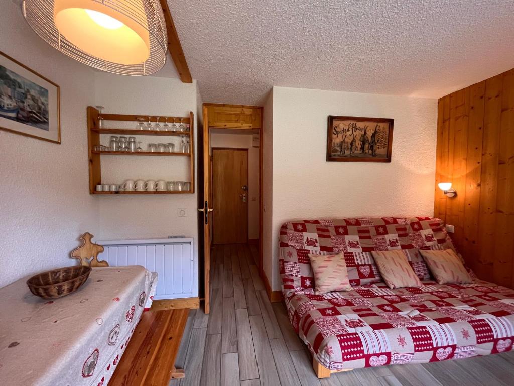 a bedroom with a bed and a wooden floor at Appartement Méribel, 2 pièces, 5 personnes - FR-1-355-247 in Les Allues