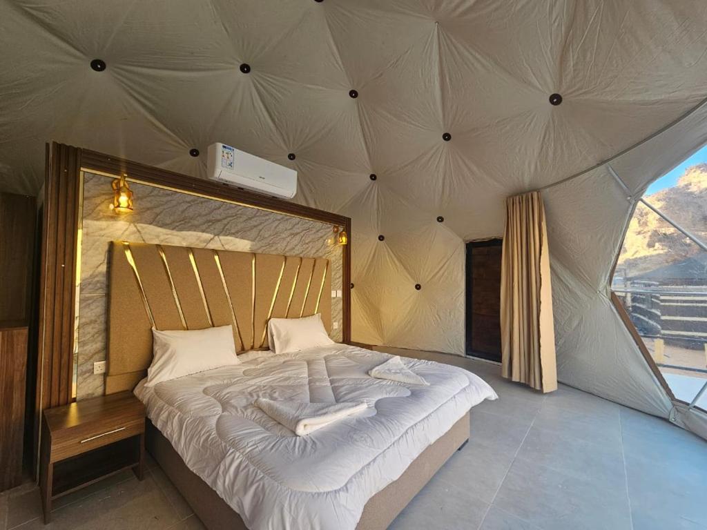 a bedroom with a large bed in a tent at غرووب وادي رم in Wadi Rum