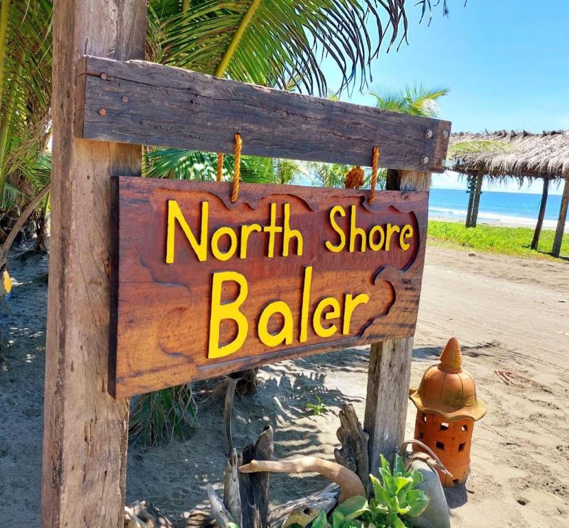 a sign for a north shore baker on the beach at North Shore Beach Resort in Baler