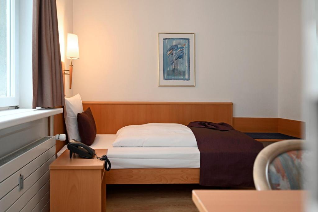Postel nebo postele na pokoji v ubytování Olympia Hotel Zurich