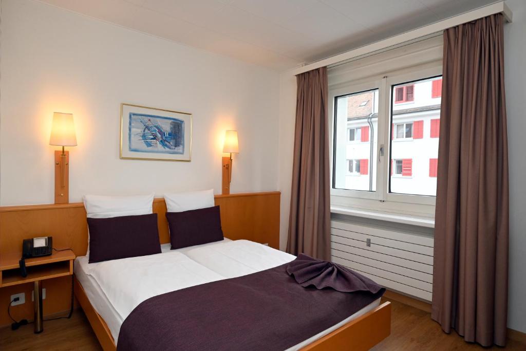 Postel nebo postele na pokoji v ubytování Olympia Hotel Zurich
