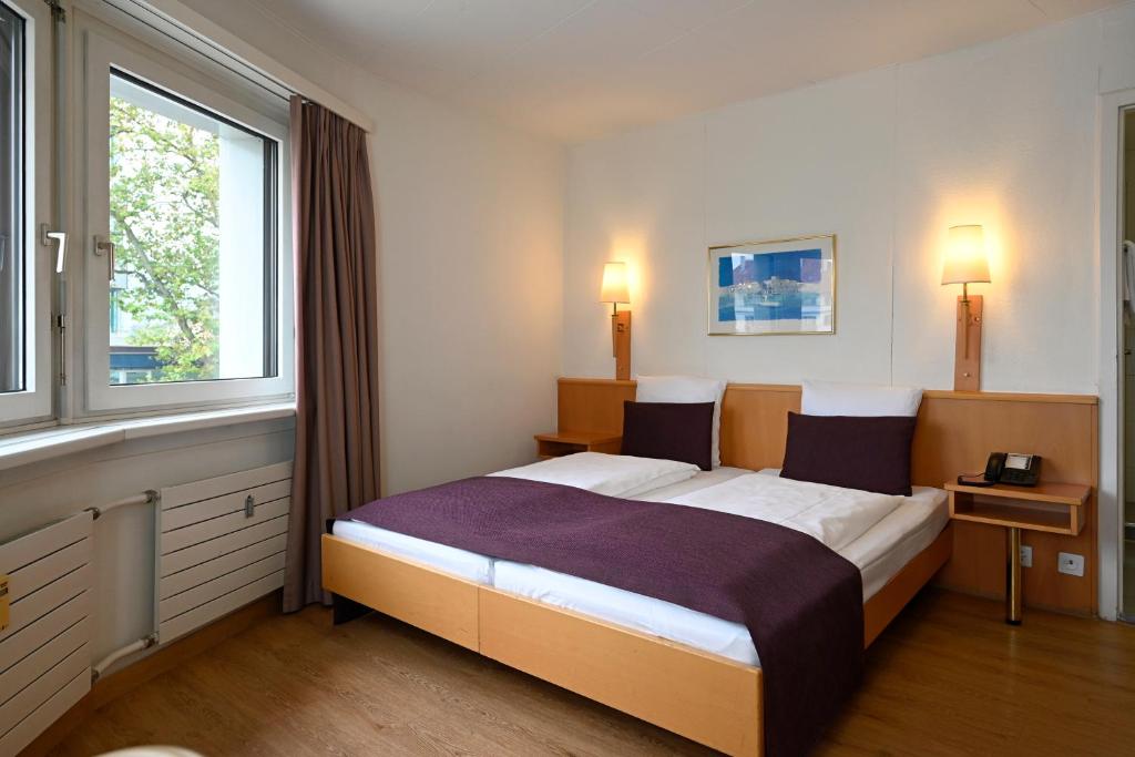 Postel nebo postele na pokoji v ubytování Olympia Hotel Zurich