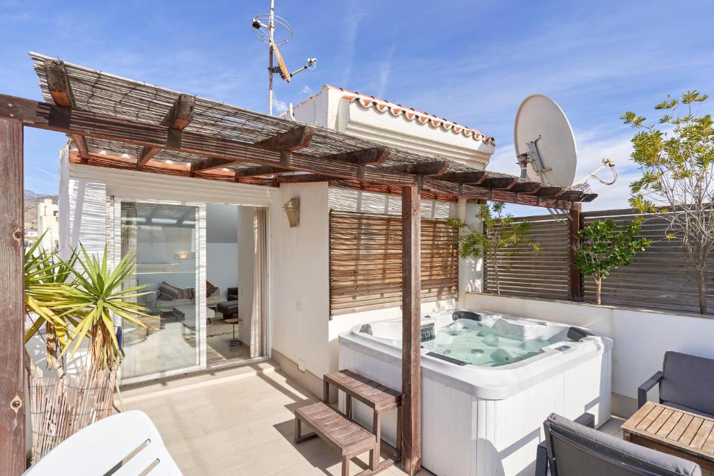 a bathroom with a tub on a patio at Luxury Penthouse apartment Nerja in Nerja