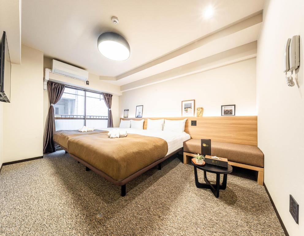 A bed or beds in a room at Lite House Shinsaibashi IV