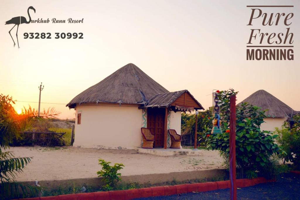 a small white house with a thatched roof at Surkhab rann resort in Dhordo