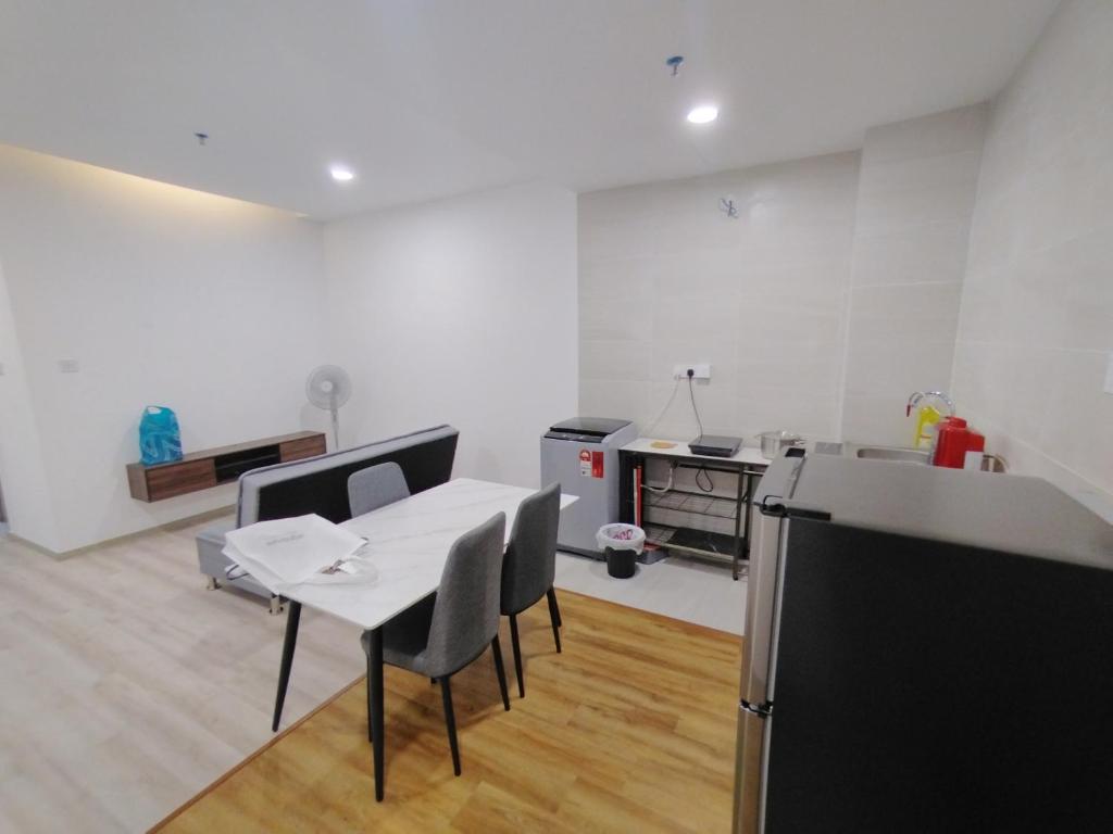 a kitchen with a table and chairs in a room at Samarahan Summer Suite Kuching AL4 in Kota Samarahan