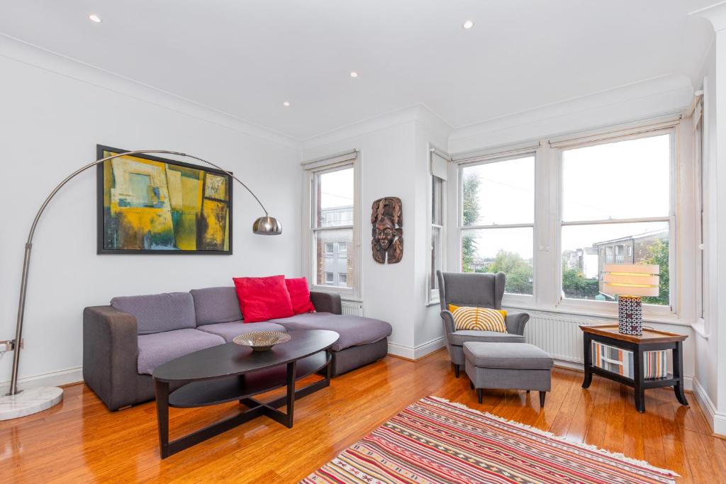 a living room with a couch and a table at Beautiful 2BR Flat, Peaceful Dulwich, South London in London
