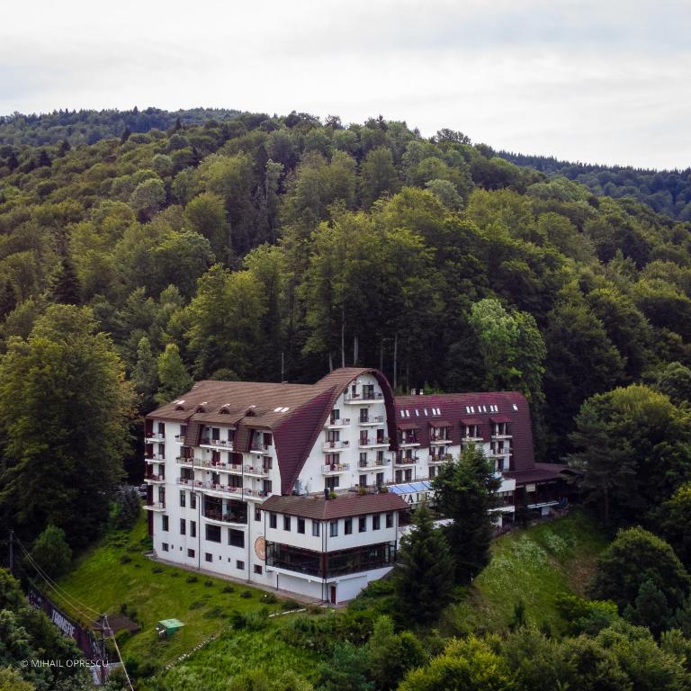 an aerial view of a building on a hill at Hotel Valea cu Pesti in Căpăţîneni-Ungureni