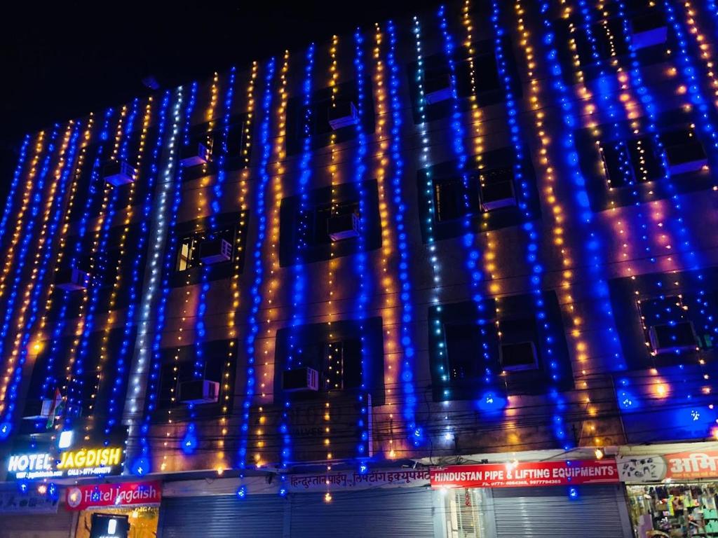 a building is lit up with blue lights at Hotel Jagdish in Raipur