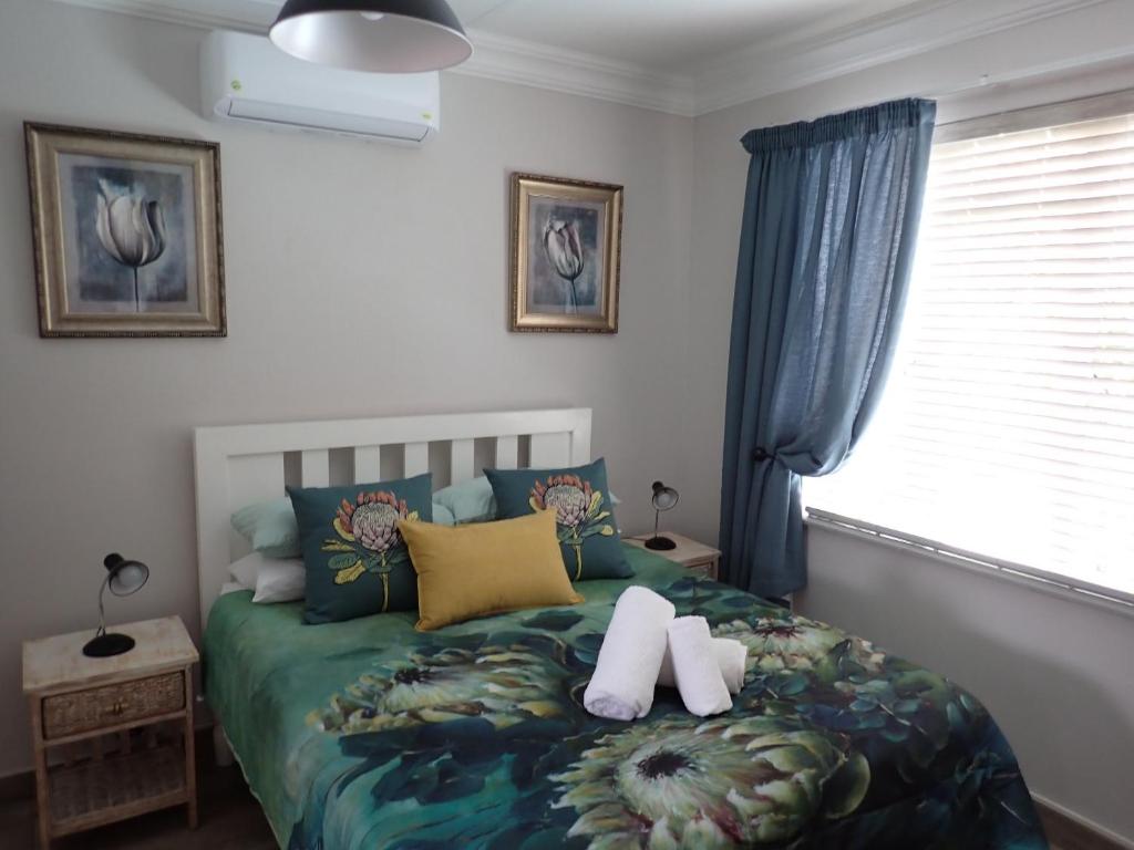 a bedroom with a bed with two towels on it at Edwil's Place in Hartbeespoort