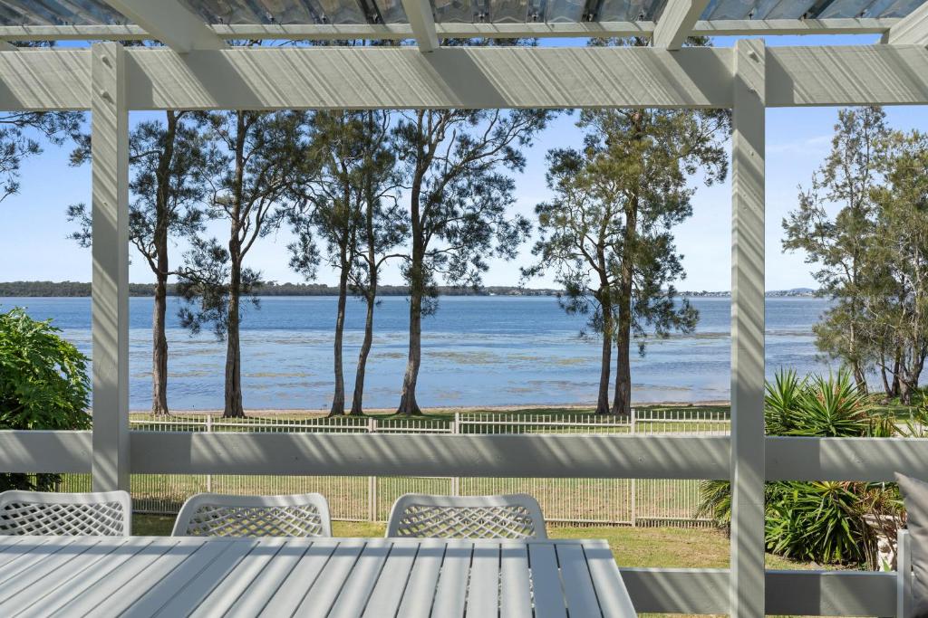 a view from the porch of a house overlooking the water at Bonus Studio Space in Budgewoi