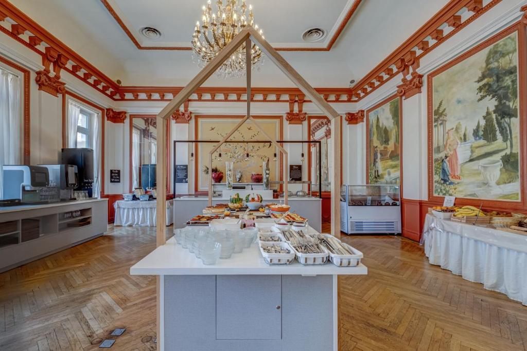a large room with a buffet of food in it at Hôtel Miléade L'Orangeraie - Menton in Menton