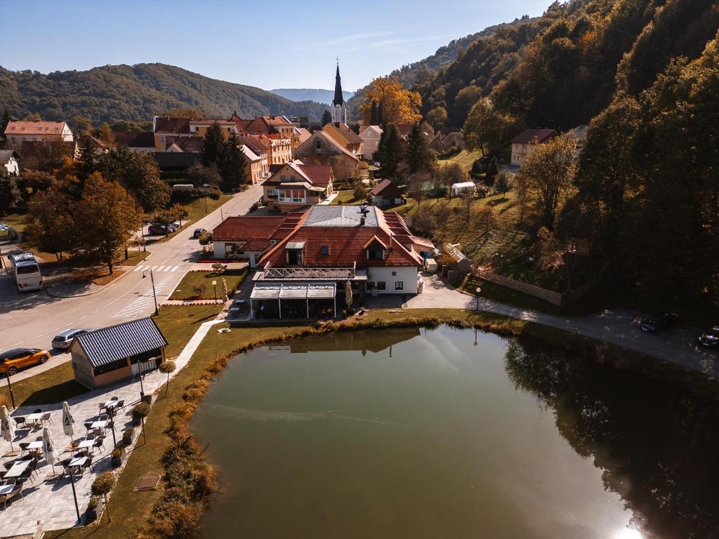 an aerial view of a town with a lake at Kozjanski dvor in Podčetrtek