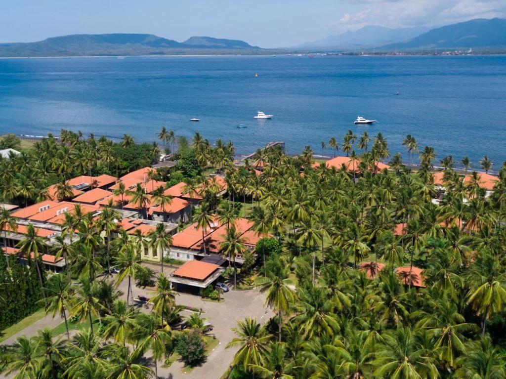 an aerial view of a resort with palm trees and the ocean at Ketapang Indah Hotel in Banyuwangi