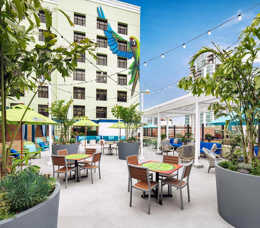 a patio with tables and chairs and a building at Margaritaville Hotel San Diego Gaslamp Quarter in San Diego
