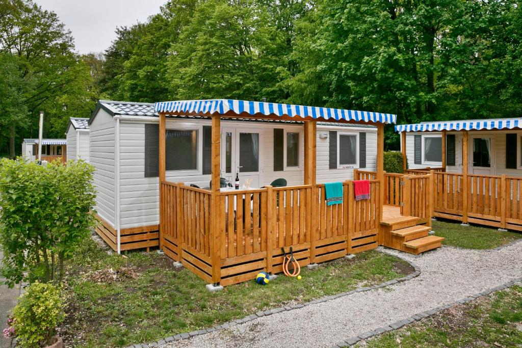 a tiny house with a porch and a deck at KNAUS Campingpark Eschwege in Eschwege