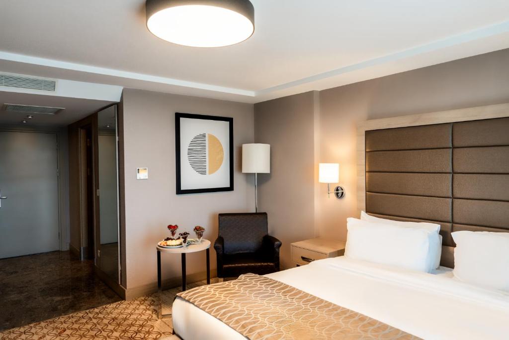 a hotel room with a bed and a chair at Nidya Hotel Galataport in Istanbul